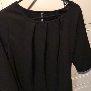 Black blouse w/ rounded neckline & pleated detail
